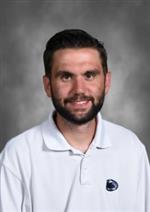 James Galligan has a beard, he is wearing a white shirt with Penn State Logo