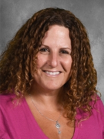 Adonna Longo has should length hair, she is wearing a pink shirt