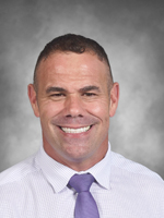 Russell Benditt is wearing a white dress shirt and tie.